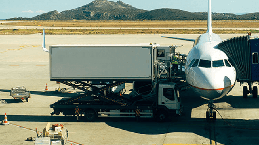 Airplane being loaded with cargo from a truck