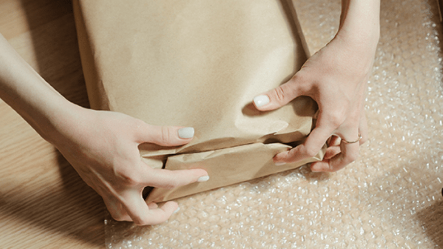 Hands wrapping a parcel